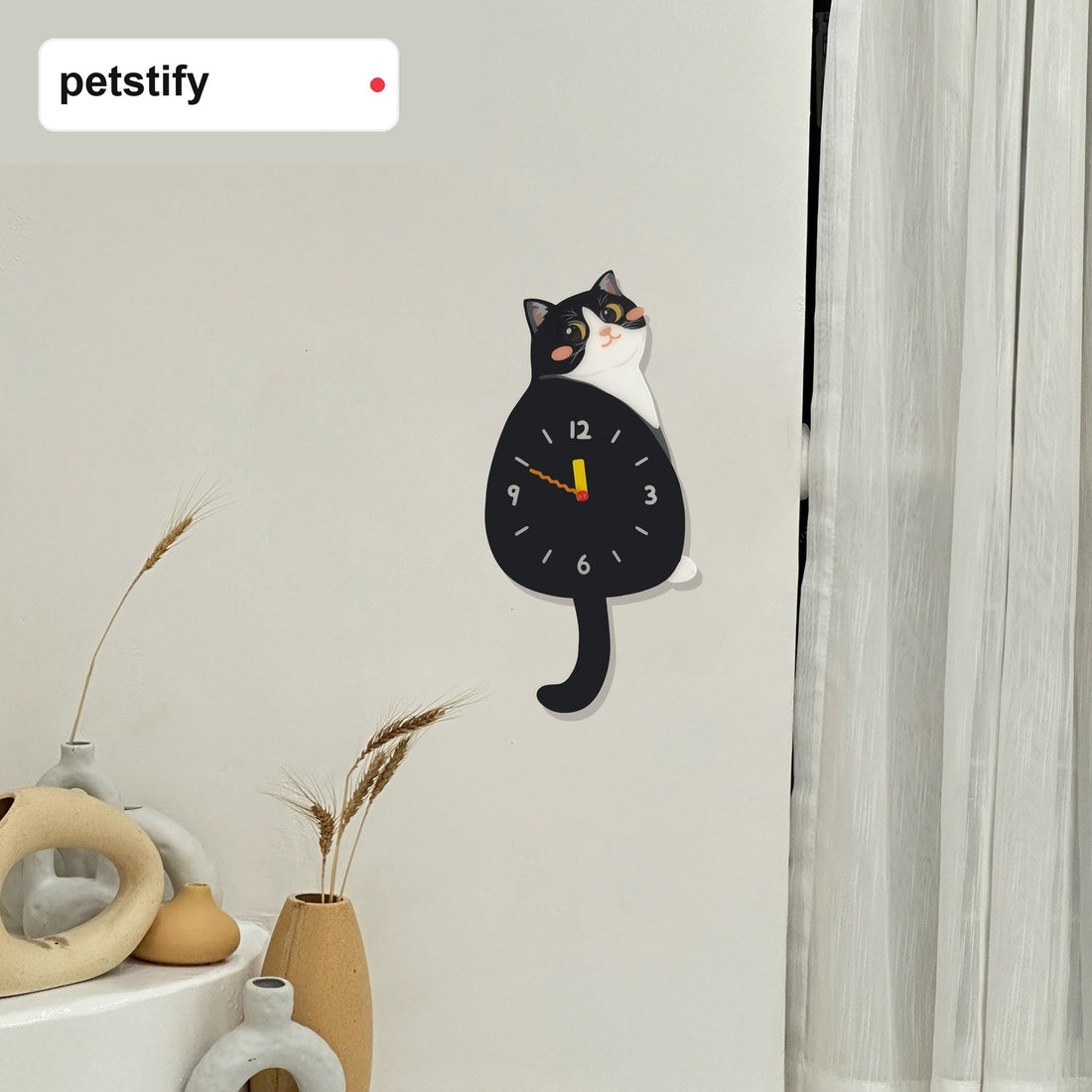 Tuxedo cat wall clock styled as playful cat-themed home decor